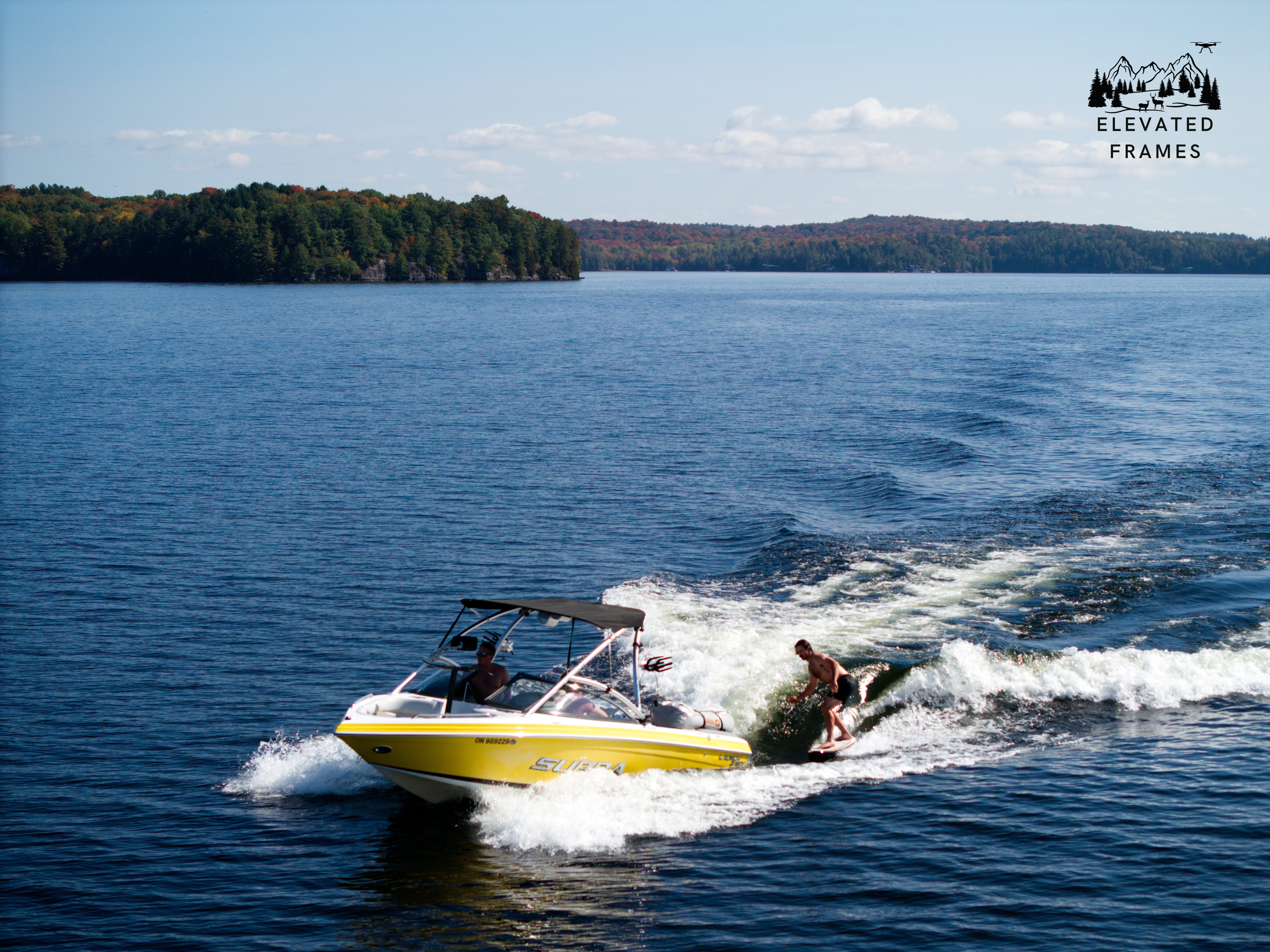 Wake surfing on a sunny summer lake
